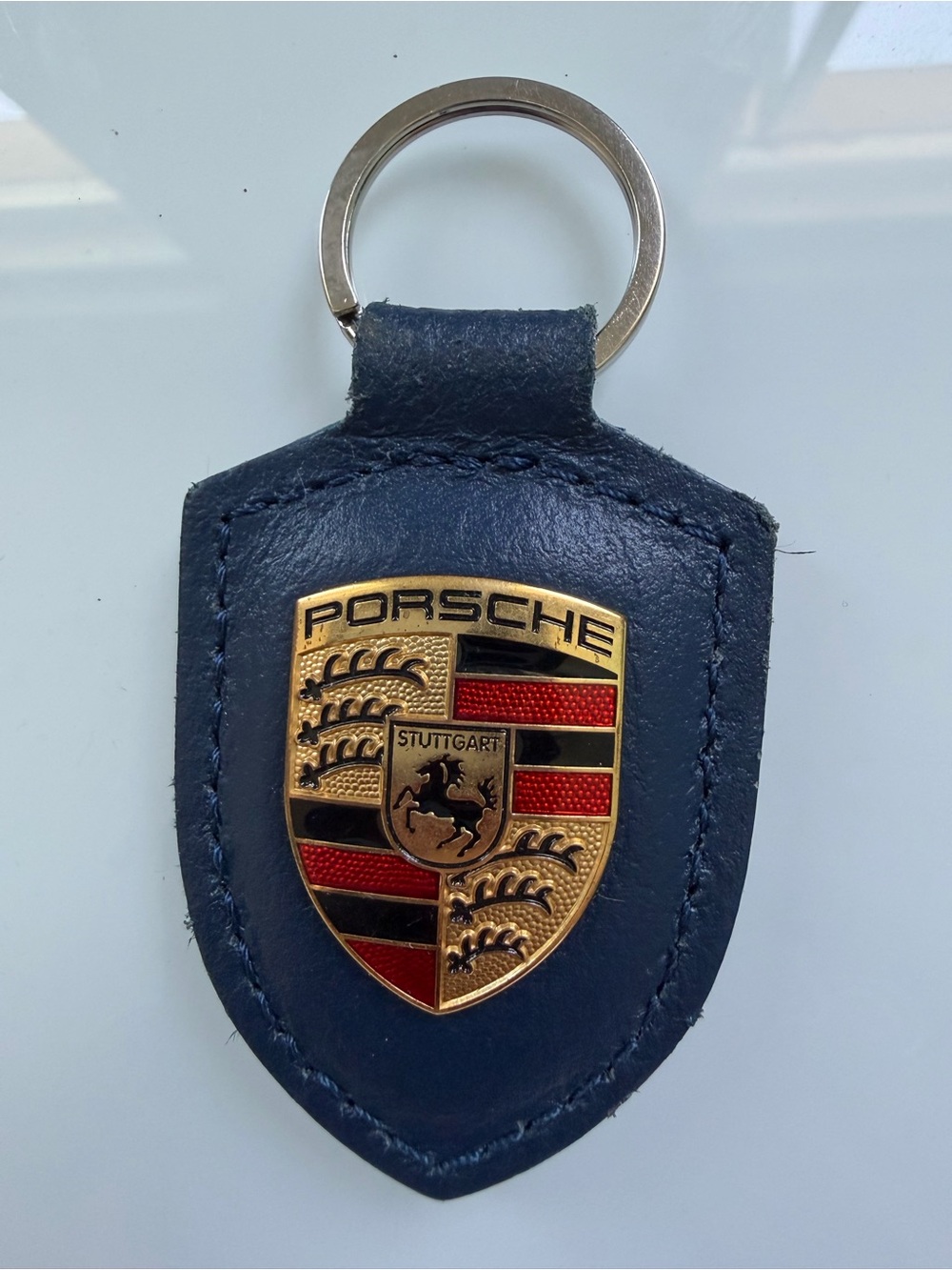 Porsche Design Navy Leather Shield Keychain with Gold Crest
